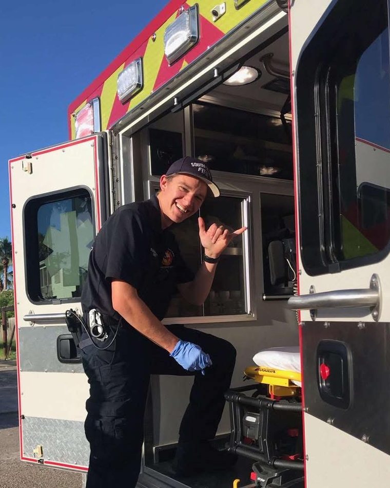 Max Ballesteros in uniform at the back of an ambulance.